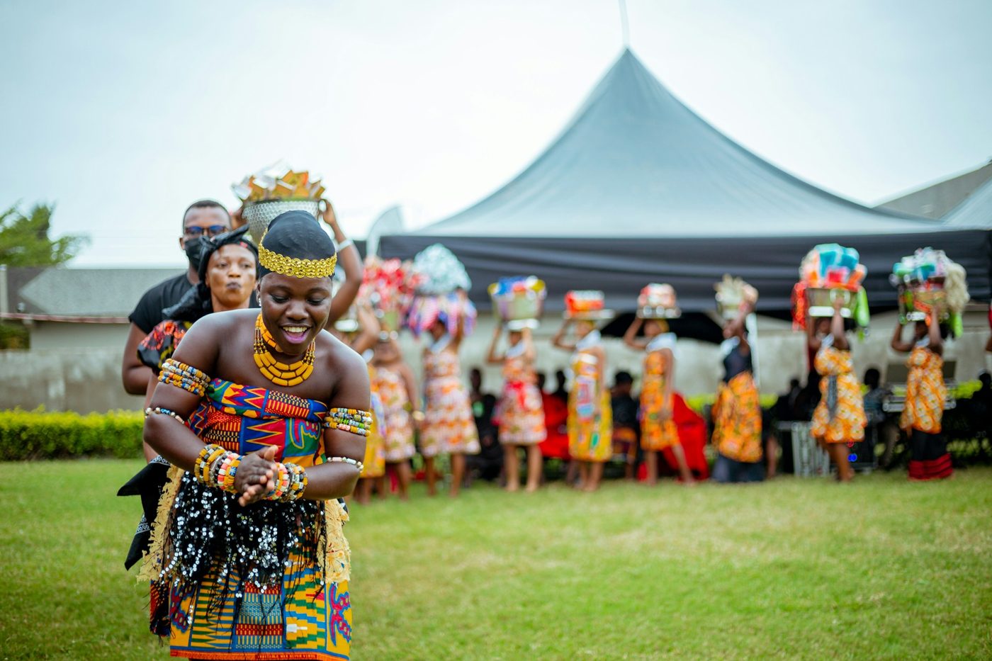 A smiling dancer leading a procession